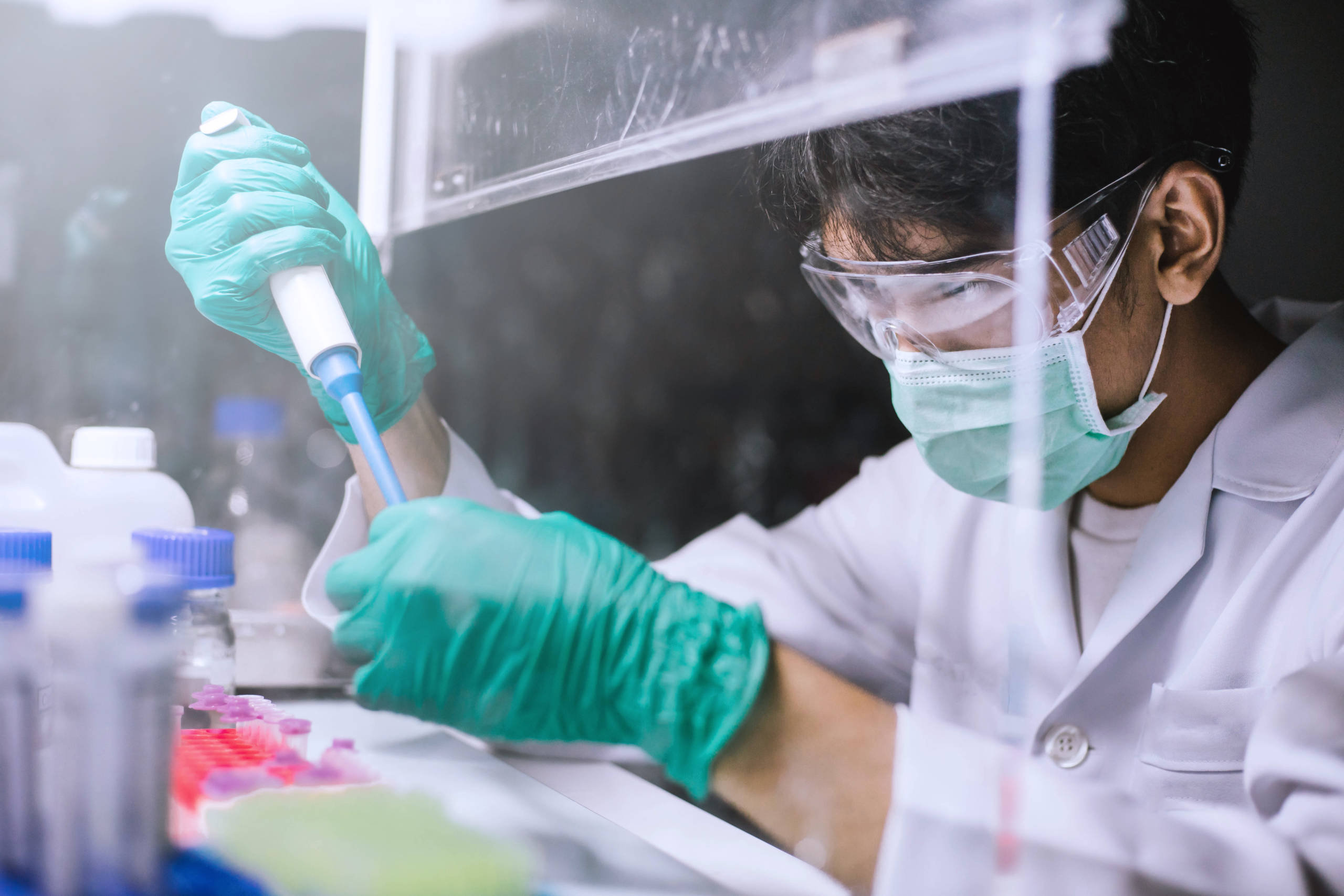 Young scientist using pipette transfer sample to Micro Centrifuge.