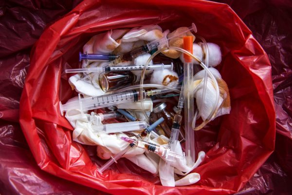 Infectious waste being disposed in red medical bag.